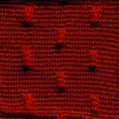 Red knit fabric texture with repeating nodes, dark markings reading “swan > fabric (super) > super 238”, and subtle tonal variations throughout.